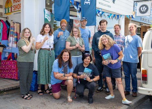 A group of Fatface employees standing outside their store