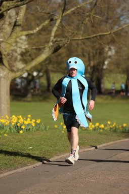 Fundraiser Paul Holland is pictured running along a path, dressed as an octopus, to raise money for the Marine Conservation Society
