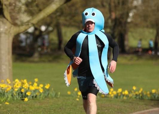 Fundraiser Paul Holland is pictured running along a path, dressed as an octopus, to raise money for the Marine Conservation Society