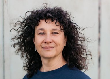 An image of Marine Conservation Society CEO, Sandy Luk, who is standing facing the camera wearing a dark blue Marine Conservation Society top