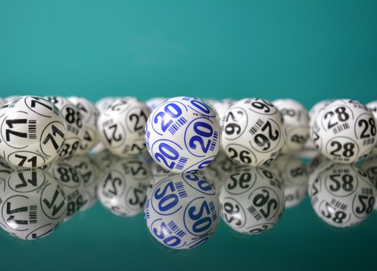 A line of lottery balls in front of a blue background