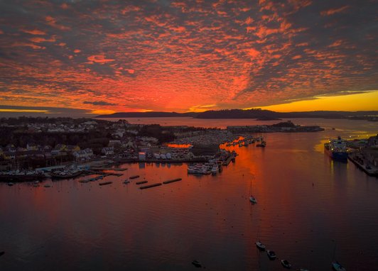 A camera shot of a sunset over th village of Oreston