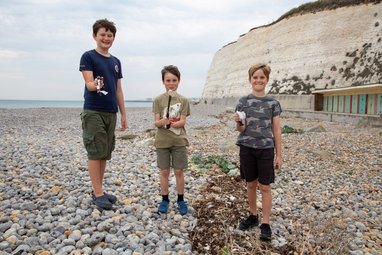 Great British Beach Clean event on a stony beach in Seaford, Sussex.