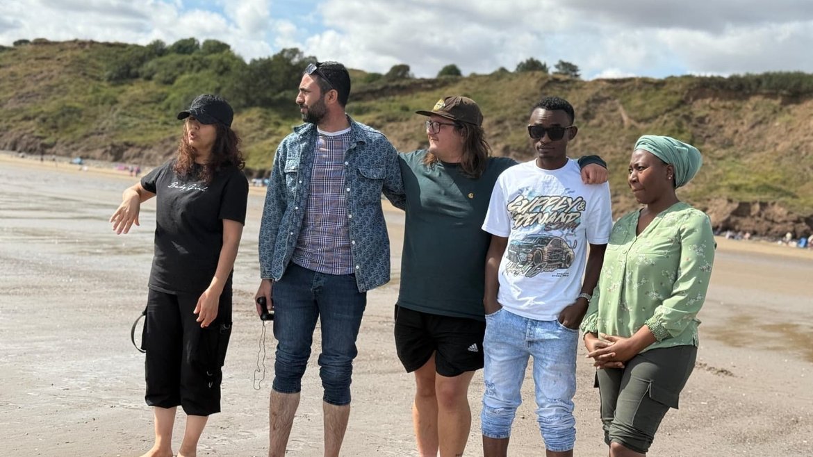 5 adults standing on Filey beach