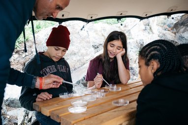 Young adults taking part in plankton sampling